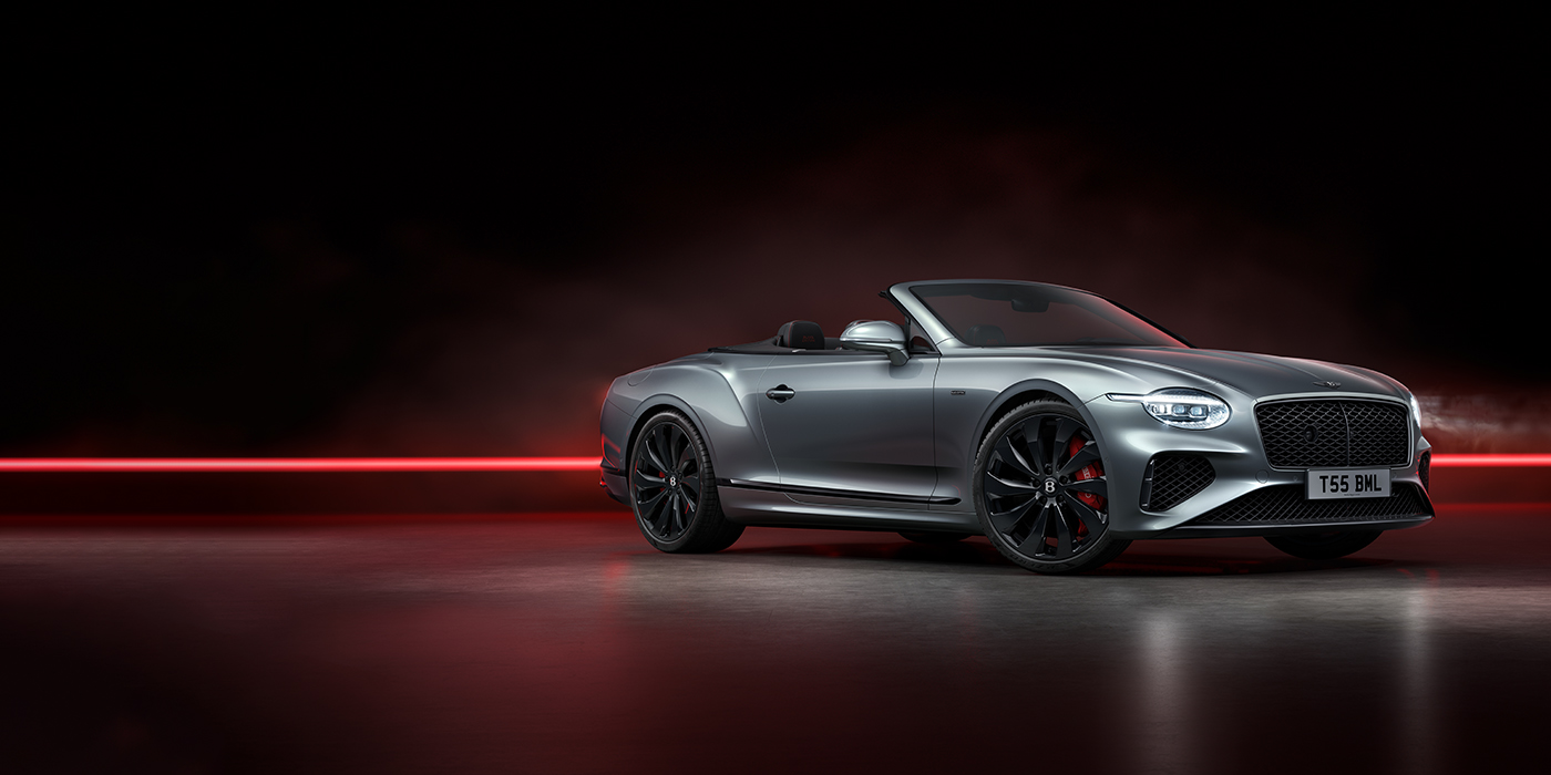 Bentley Porto Bentley Continental GTC Black Edition convertible front three quarters in Hallmark silver against a dark grey and red background