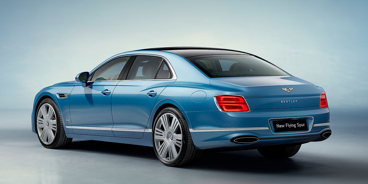 Bentley Porto New Bentley Flying Spur Azure sedan rear view in Light windsor blue by Mulliner paint with 22 inch Azure wheels and chrome exterior details