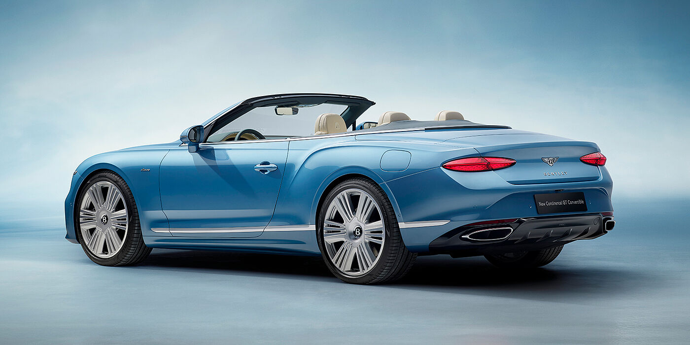 Bentley Porto New Bentley Continental GTC Azure convertible rear view in Light Windsor blue paint with 22 inch ten spoke wheels and chrome exterior details