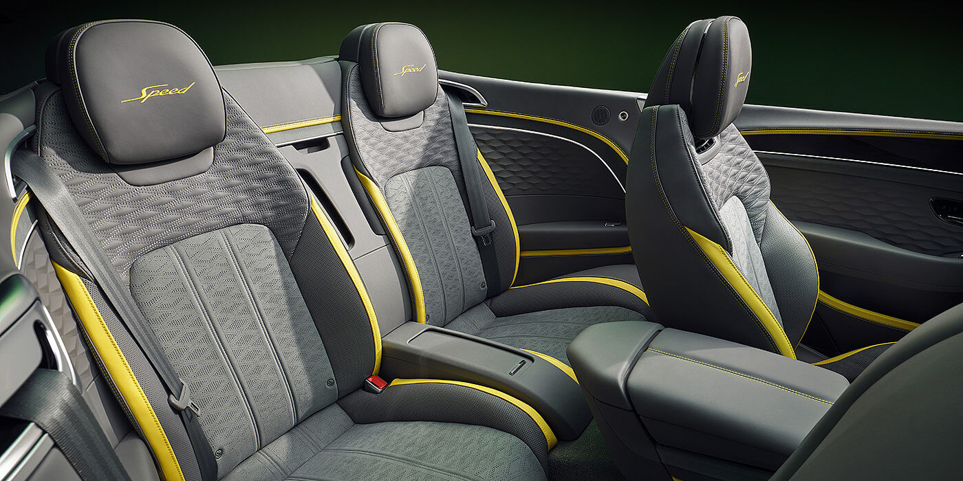 Bentley Porto Bentley New Continental GTC Speed convertible rear interior with unique Speed colour split in Gravity Grey and Cyber Yellow hide colours, and contrast stitched headrest emblems 