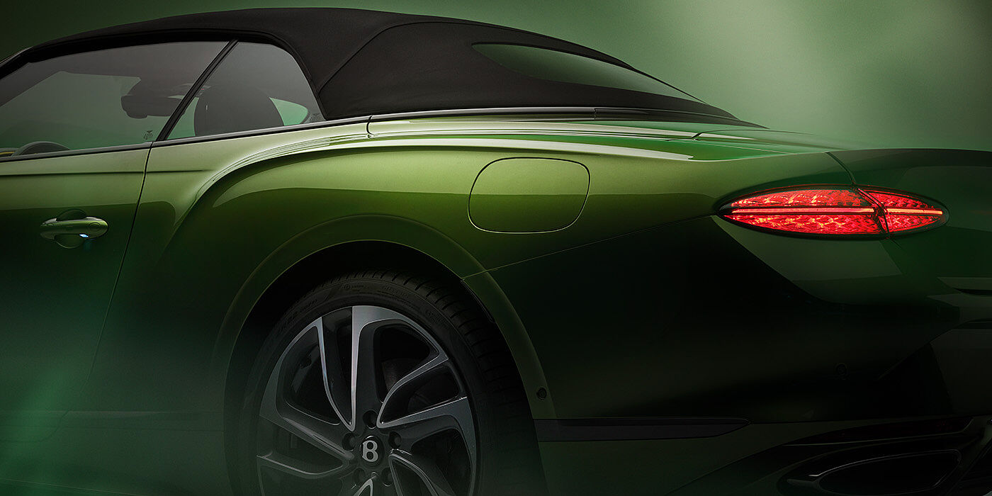 Bentley Porto Bentley New Continental GTC Speed rear haunch and tail lamp in Tourmaline Green paint and dark tint brightware with black hood up and illuminated head lamps