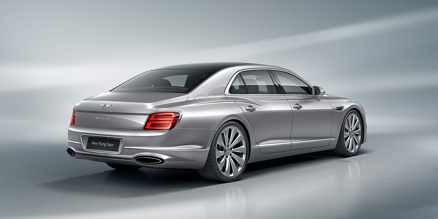 Bentley Porto New Bentley Flying Spur sedan rear view in Silverlake paint with ten spoke wheels and chrome matrix grille