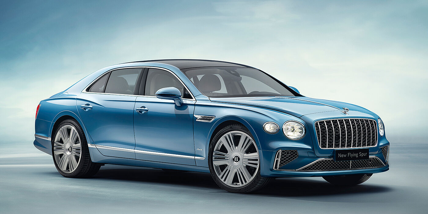 Bentley Porto New Bentley Flying Spur Azure sedan front view in Light windsor blue by Mulliner paint with 22 inch Azure wheels and chrome exterior details