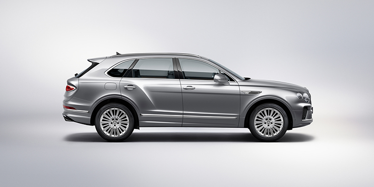 Bentley Porto Bentley Bentayga SUV side profile in Moonbeam silver paint against white background featuring 21 inch 5 spoke wheels